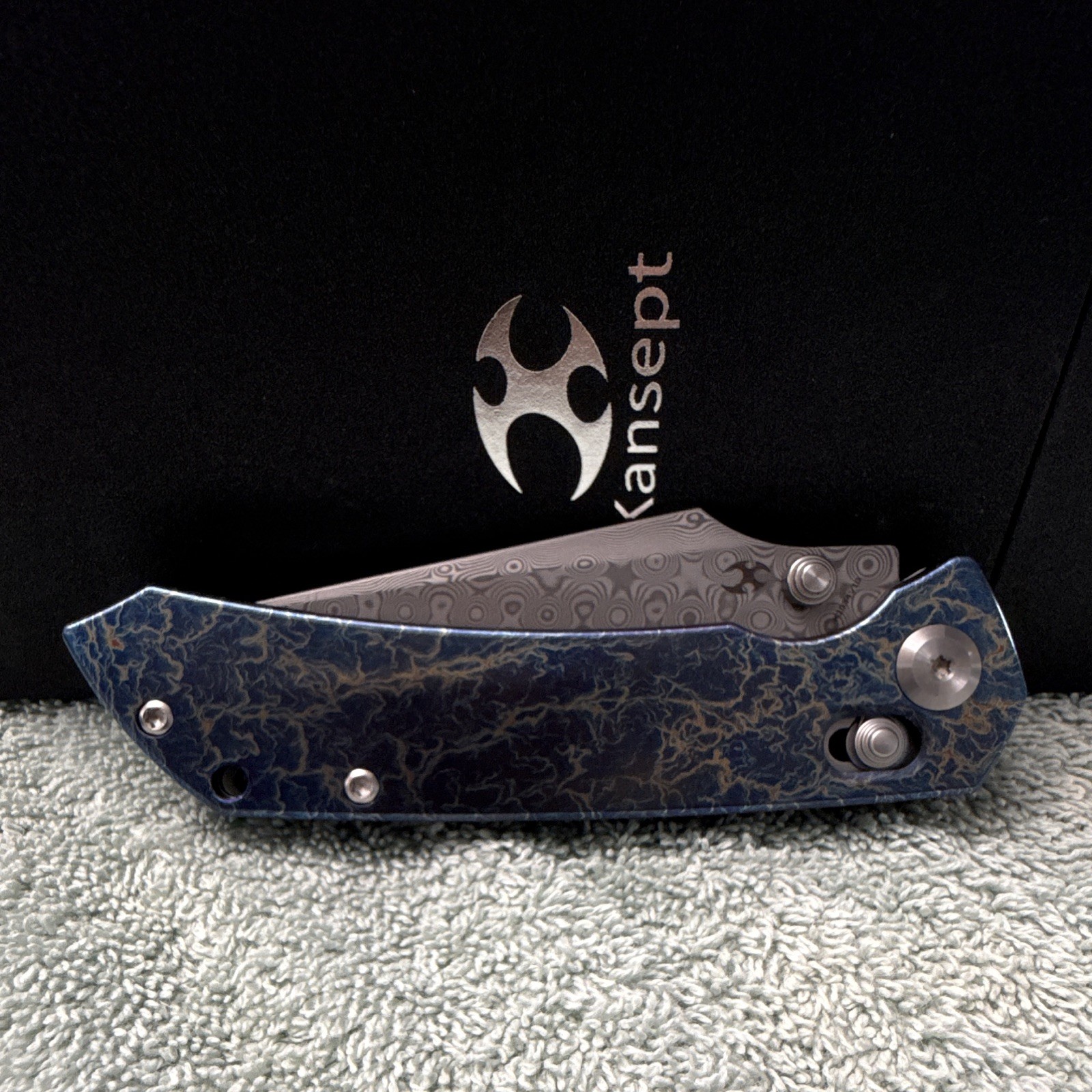 Kansept Fenrir | Damascus Steel Manual Drop Point Plain | Button Lock Ti Blue