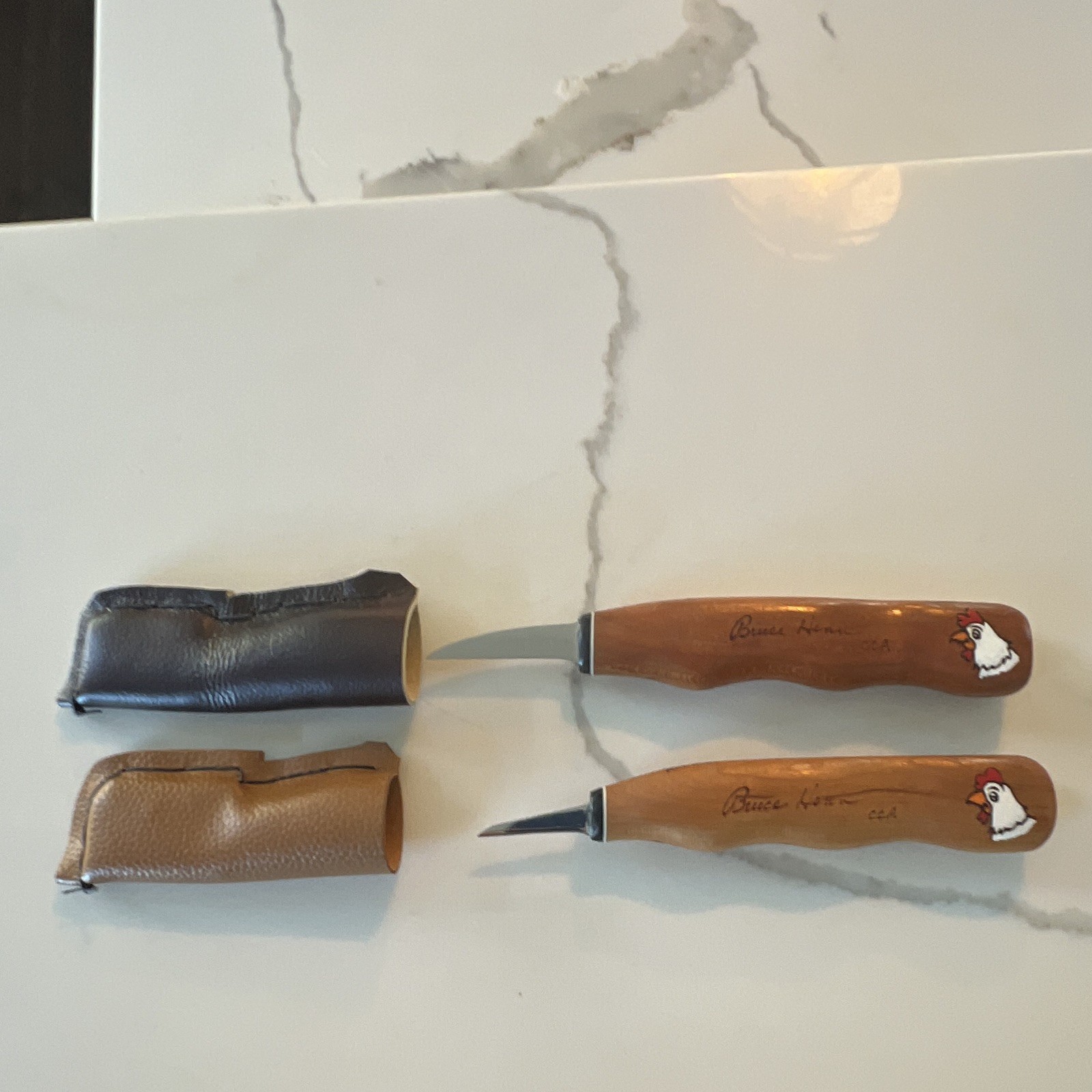 Set of 2 Bruce Henn Helvie Wood cutting knives with signature painted Rooster.