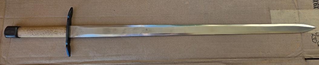 Hand and a half medieval sword, very sturdily built, dull edges, black sheath