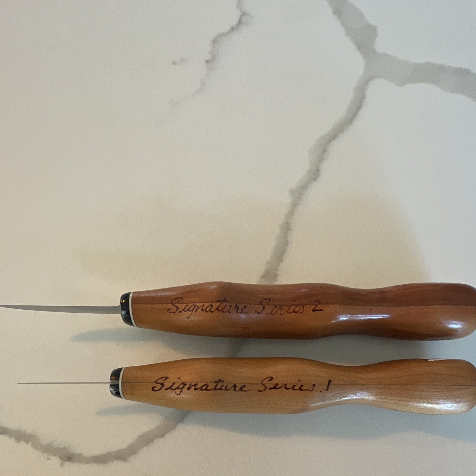 Set of 2 Bruce Henn Helvie Wood cutting knives with signature painted Rooster.