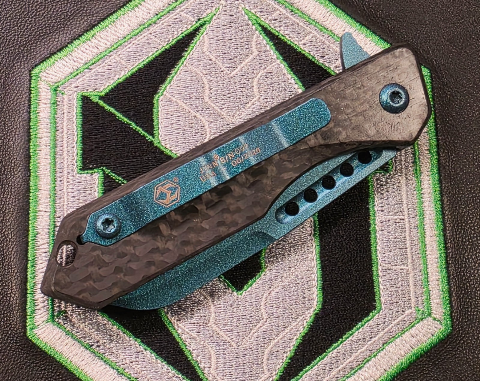 Heretic Jinn Button Lock Flipper Metallic Teal MagnaCut Carbon Fiber Handles