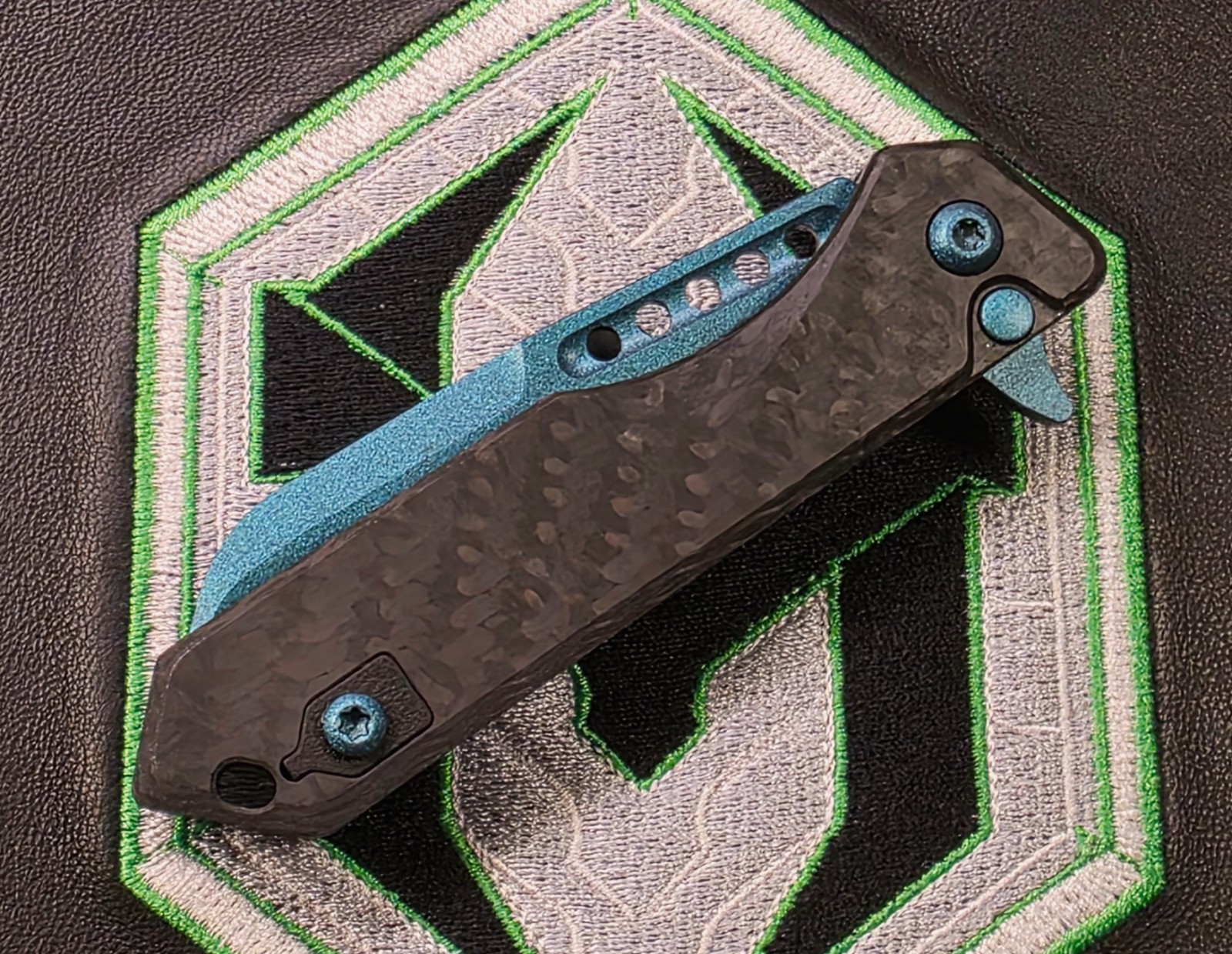 Heretic Jinn Button Lock Flipper Metallic Teal MagnaCut Carbon Fiber Handles
