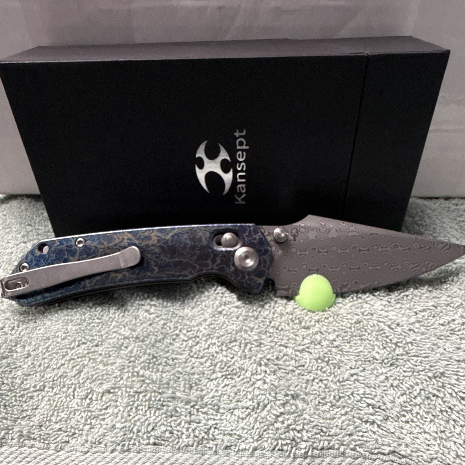 Kansept Fenrir | Damascus Steel Manual Drop Point Plain | Button Lock Ti Blue