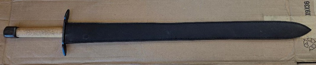 Hand and a half medieval sword, very sturdily built, dull edges, black sheath