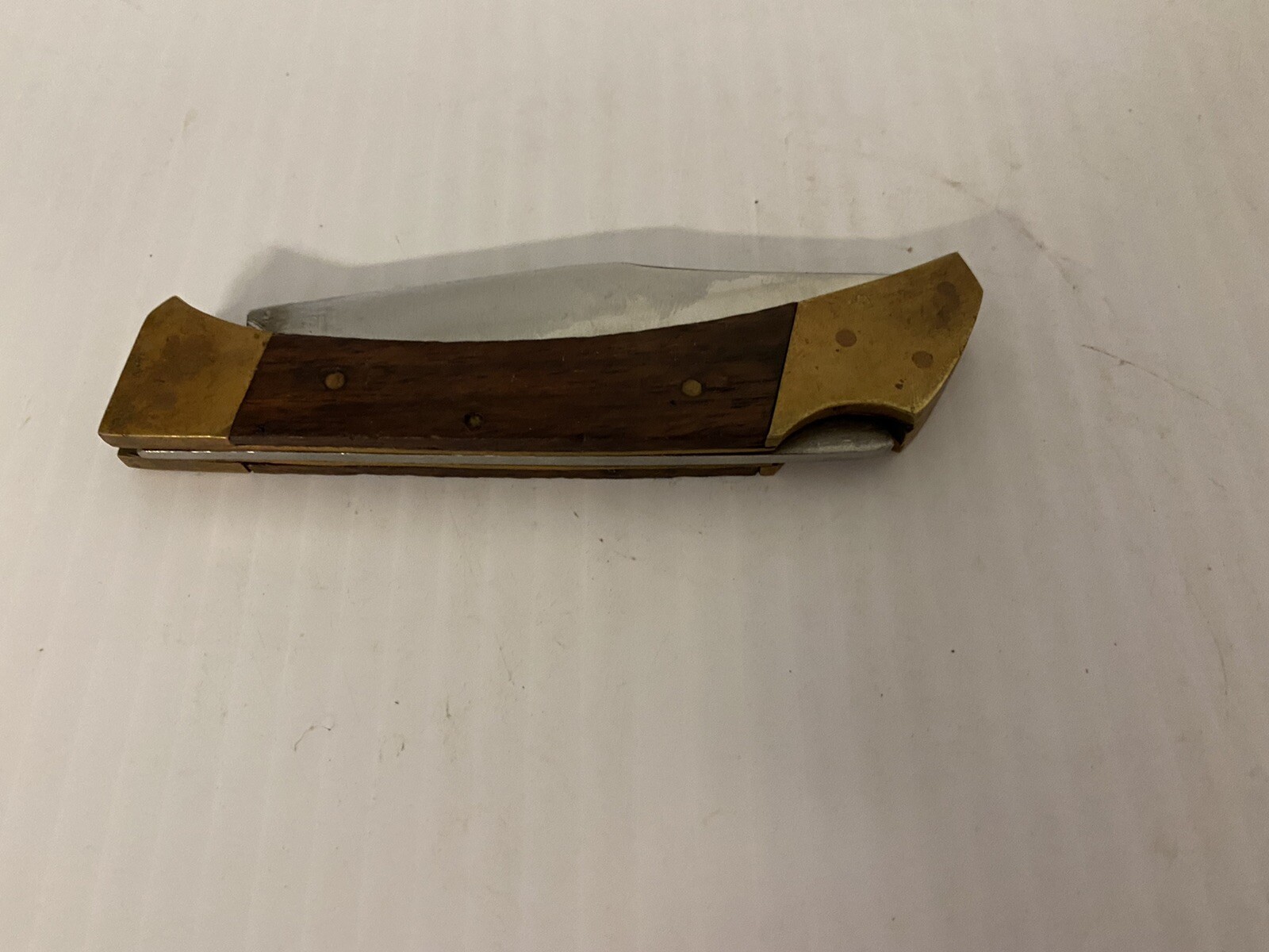 Brass and woodgrain small pocket knife