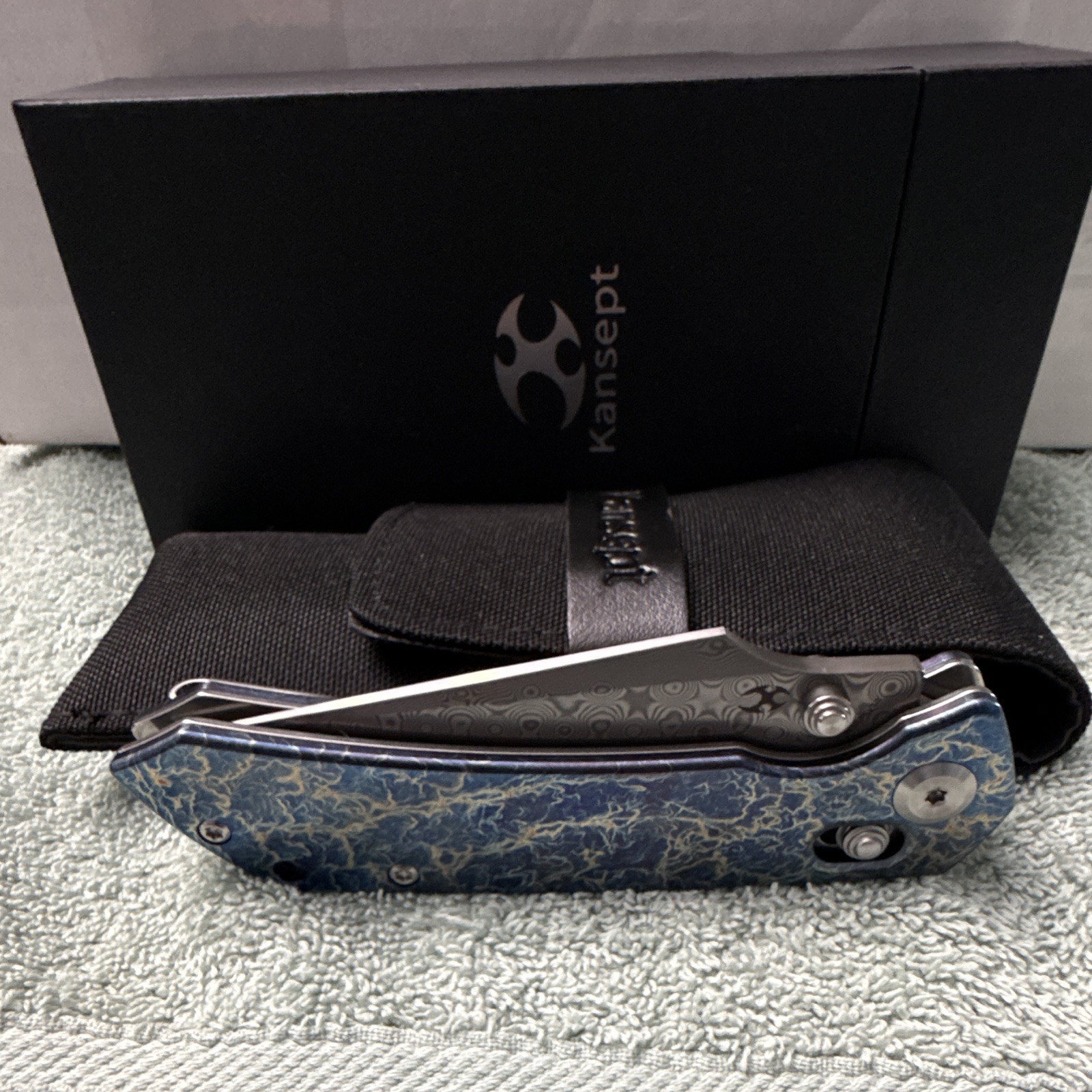 Kansept Fenrir | Damascus Steel Manual Drop Point Plain | Button Lock Ti Blue