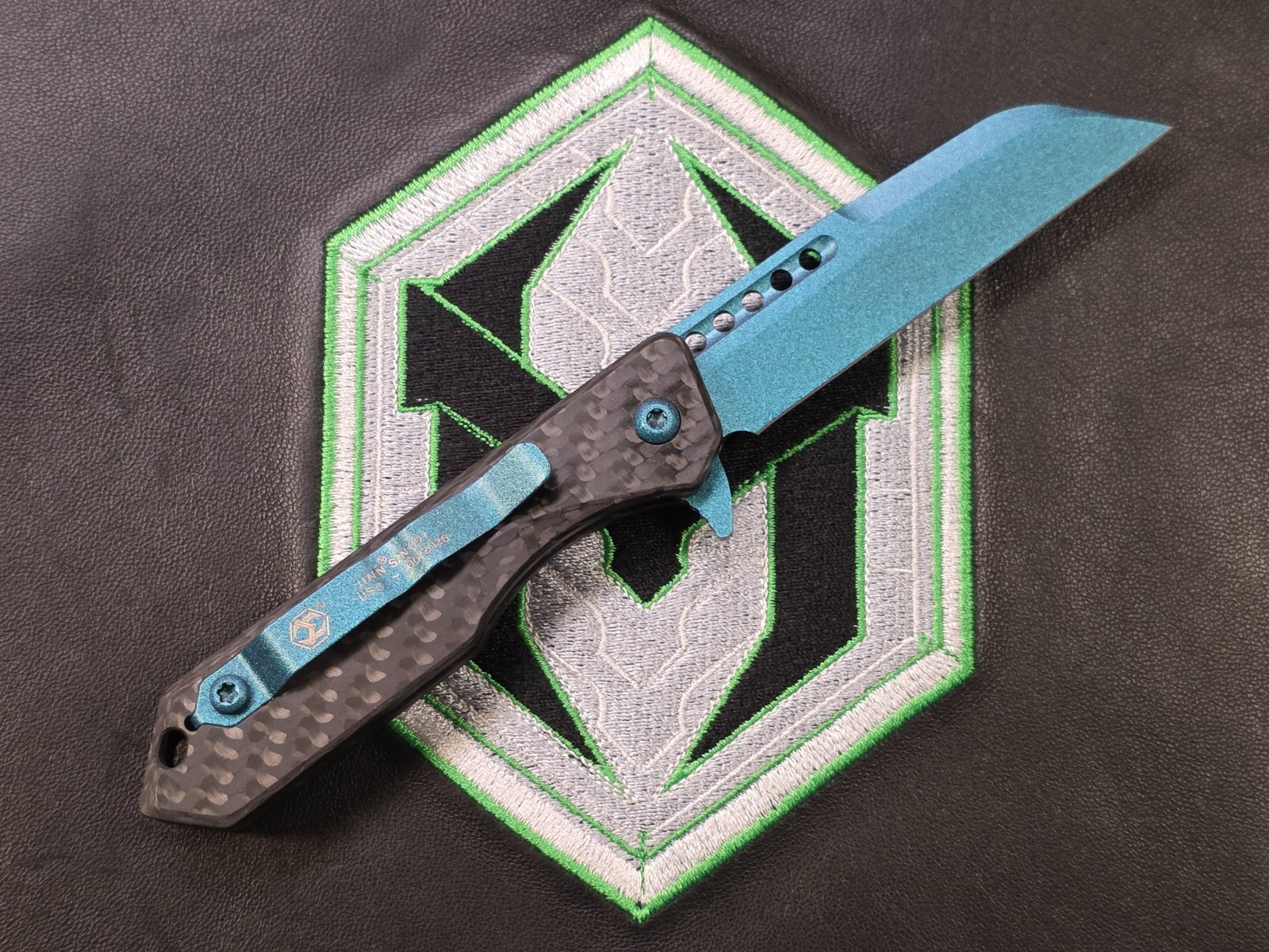Heretic Jinn Button Lock Flipper Metallic Teal MagnaCut Carbon Fiber Handles