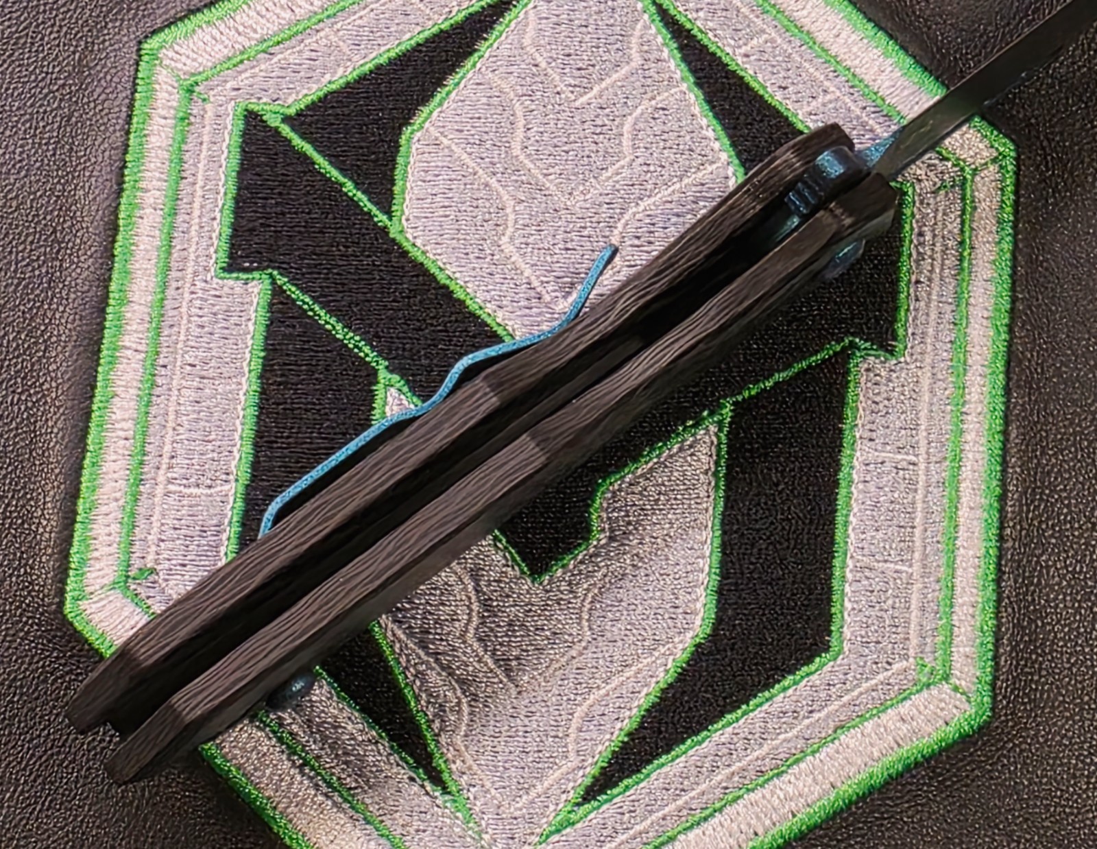 Heretic Jinn Button Lock Flipper Metallic Teal MagnaCut Carbon Fiber Handles